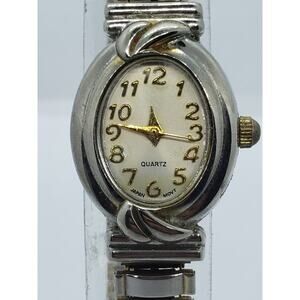White Stag women's dress watch. Light gold face with unique wave buckle on band
